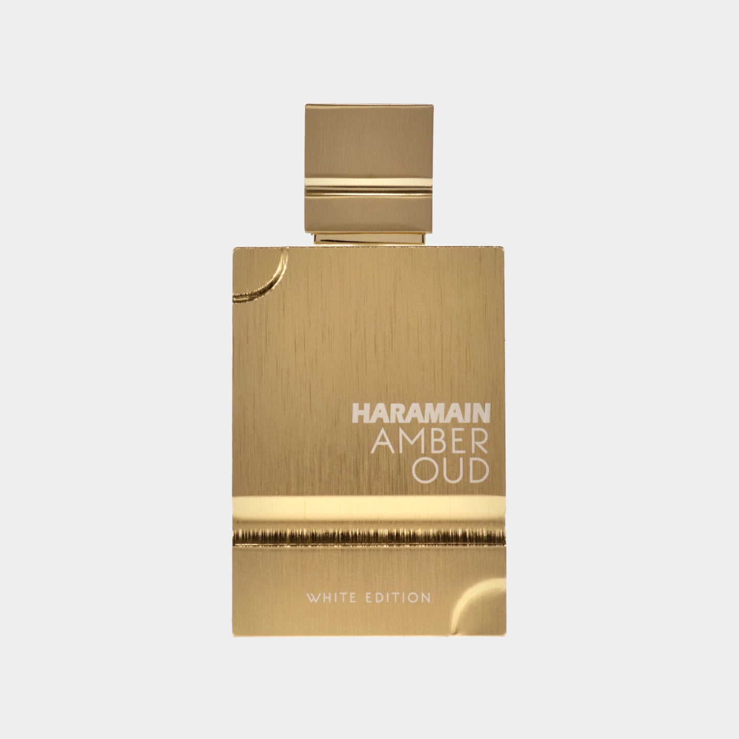 Monsterflesje van Al Haramain Amber Oud White Edition Cologne, met een elegante gouden verpakking en witte tekst, perfect voor een luxe geurervaring.