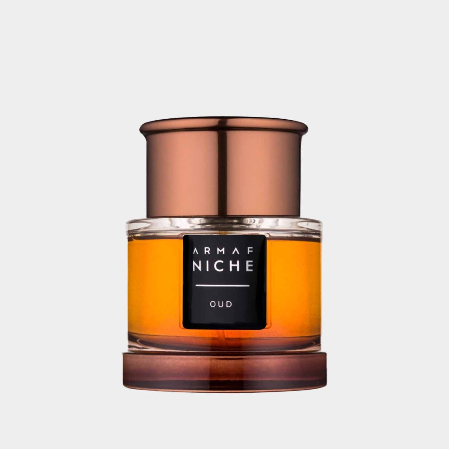 Een elegant parfumflesje van Armaf Niche Oud, met een goudkleurige vloeistof en een luxe, koperkleurige dop. Dit sample biedt een rijke, houtachtige geurervaring.
