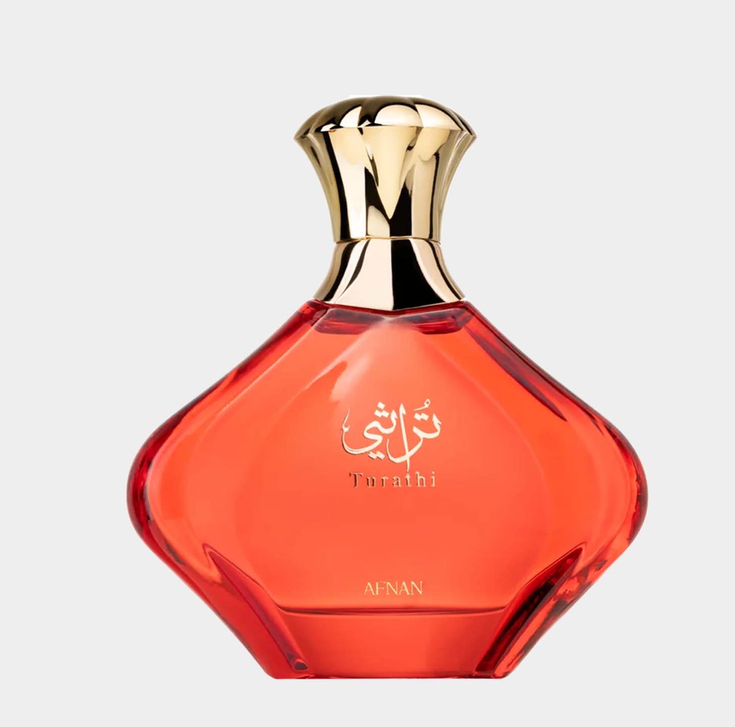 Afnan Perfumes Turathi Red Sample, een elegante fles met een opvallende oranje tint en gouden dop, perfect voor een luxe geurervaring.