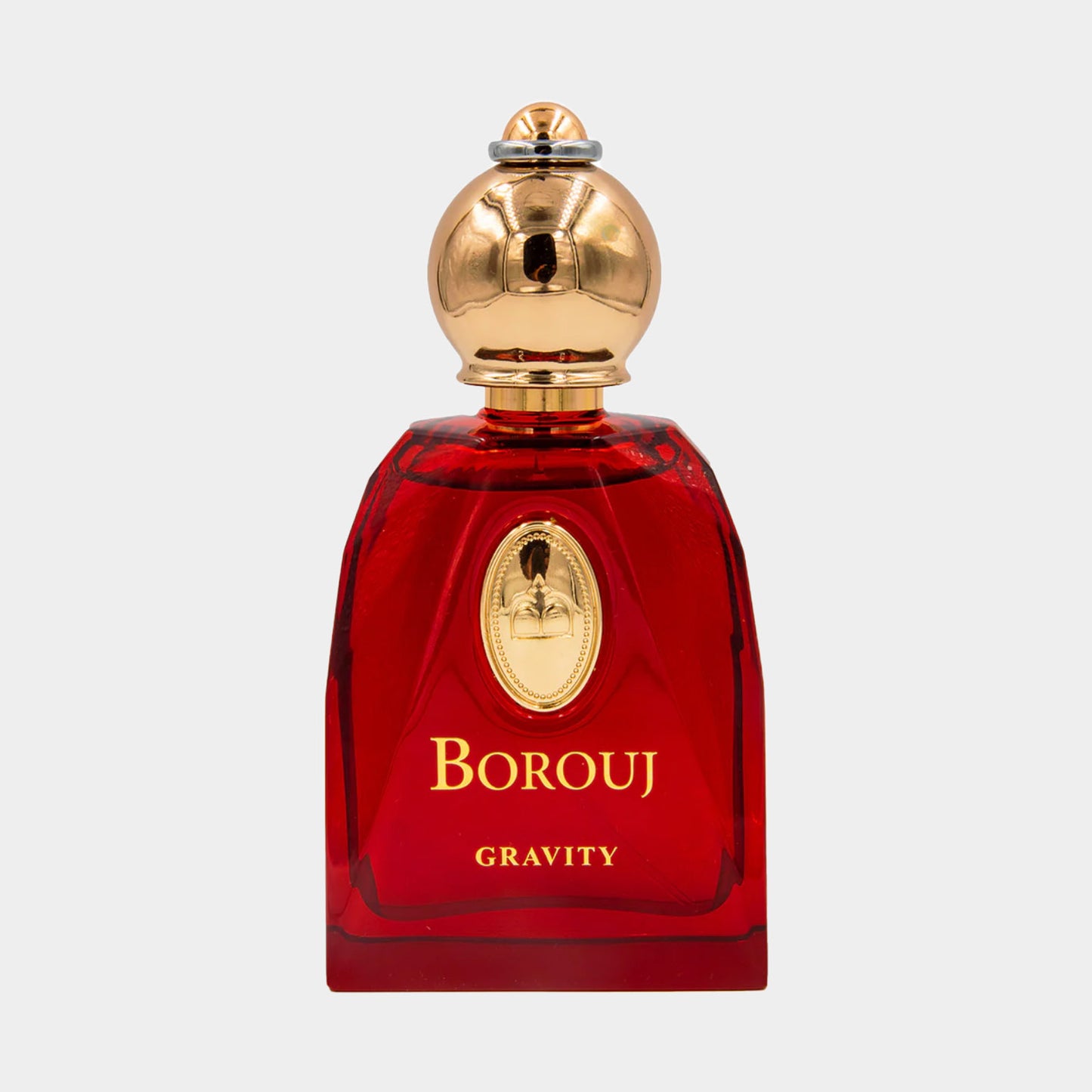 Fles van Borouj Gravity, een luxe parfum, met een opvallende rode glazen verpakking en een gouden dop.