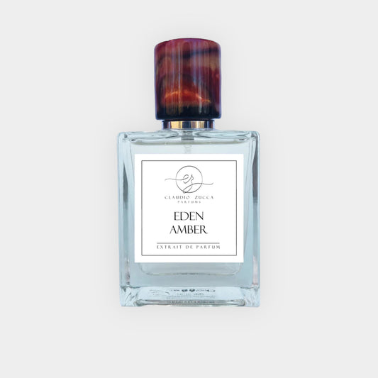 Claudio Zucca Eden Amber Sample, een elegante fles met een donkerbruin dop en een minimalistisch etiket met de naam van het parfum, perfect voor een luxe geurervaring.