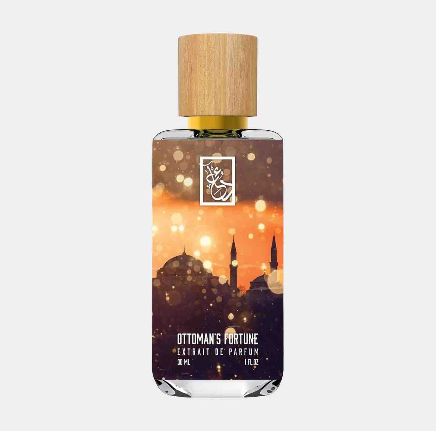 Dua Ottomans Fortune Sample, een parfum in een elegante fles met een houten dop, versierd met een silhouet van een indrukwekkend stadlandschap in gouden tinten.