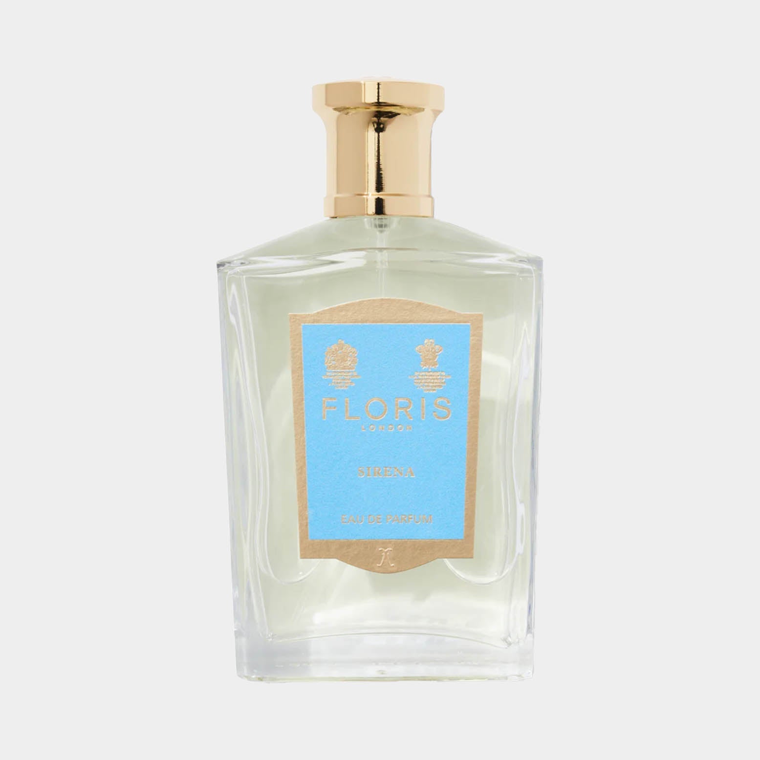 Een glazen parfumfles van Floris London Sirena, met een blauwe label en een gouden dop. Deze Eau de Parfum straalt elegantie en verfijning uit.