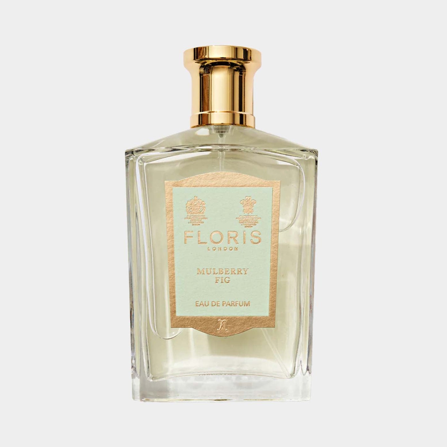 Een flacon eau de parfum van Floris London met de geur Mulberry Fig. Het glazen flesje heeft een elegant ontwerp en een gouden dop.