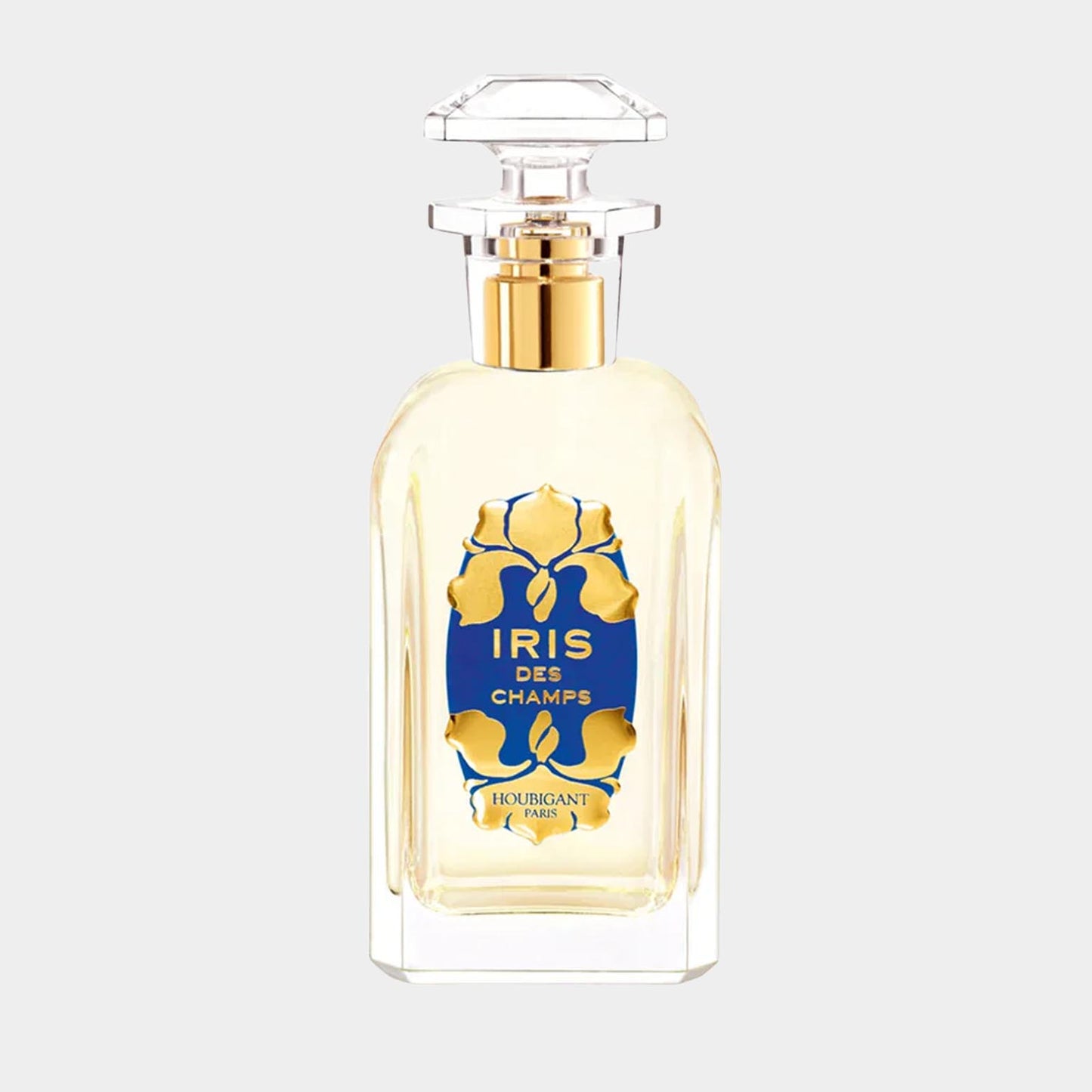 Een volle fles Houbigant Iris des Champs parfum, duidelijk zichtbaar met een elegante glazen fles en een opvallend blauw etiket met gouden details.