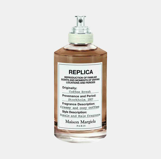 Maison Martin Margiela Replica Coffee Break Sample is a stylish fragrance bottle featuring a label that describes its scent as creamy and cozy coffee, evoking a warm moment in Stockholm, 2007.