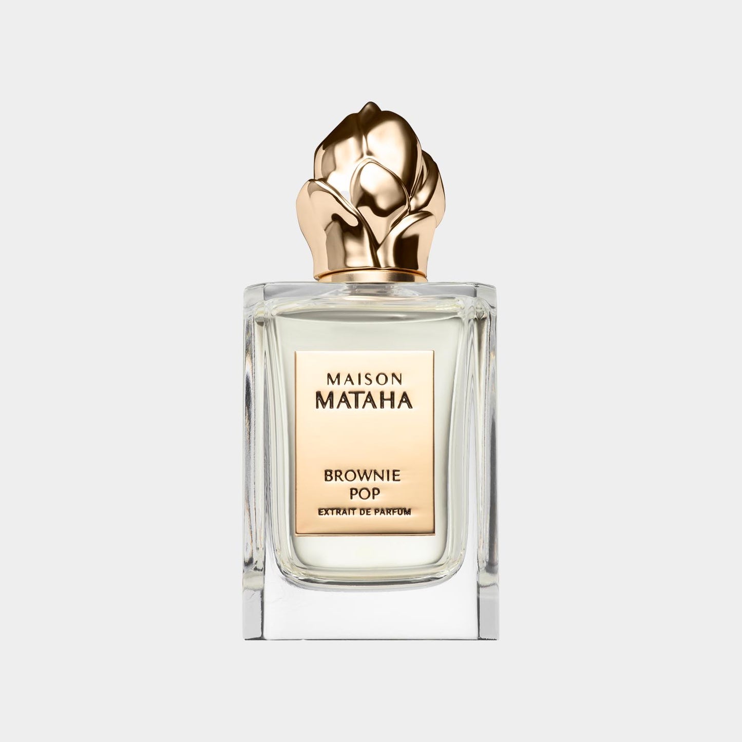 Maison Mataha Brownie Pop Sample, een elegant parfumbottle met een gouden bloemtop en een luxe uitstraling.