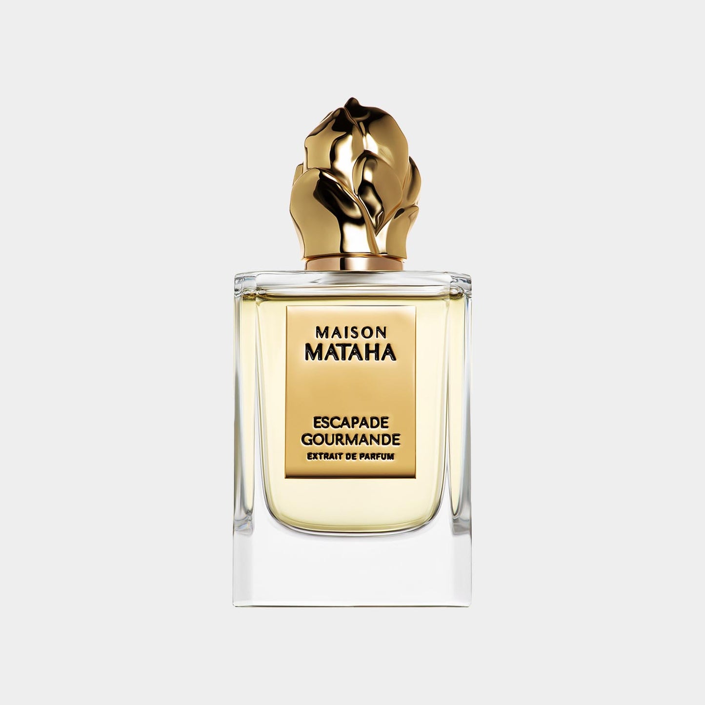 Fles van Maison Mataha Escapade Gourmande Sample, een luxe parfum met een elegant design en een gouden dop in de vorm van handen.