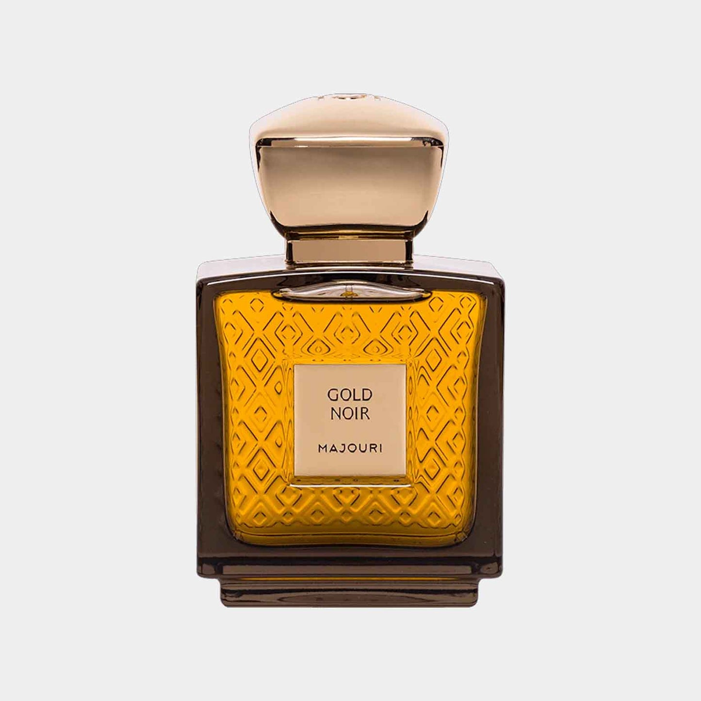 Majouri Gold Noir Sample – een elegante parfumfles met een gouden gegraveerde uitstraling en een warme, amberkleurige vloeistof.
