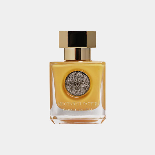 Nectar Olfactif Secret du Nil Sample in a elegante flacon met een gouden dop en gedetailleerde zilveren decoratie, perfect voor een verfijnde geurbeleving.