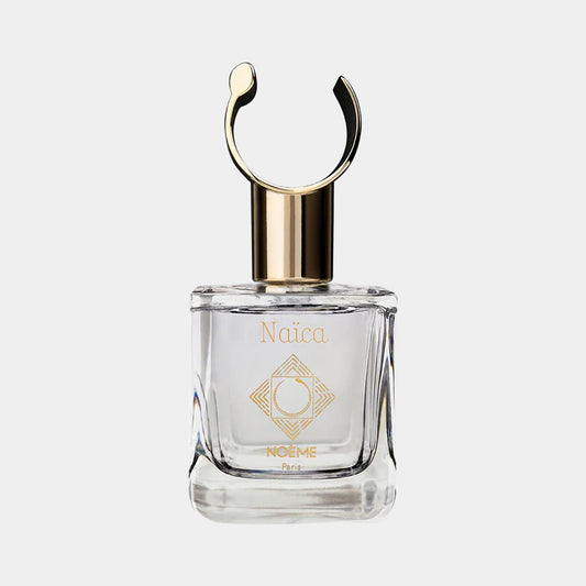 Noème Paris Naïca Sample, een elegant glazen parfumflesje met een gouden dop en een uniek design, perfect voor een luxe geurervaring.