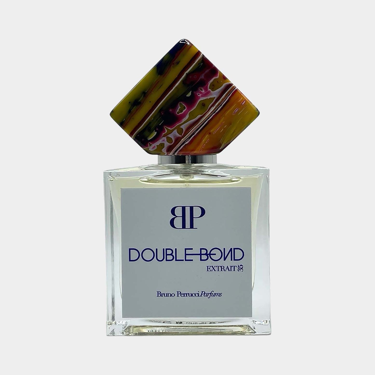 Bruno Perrucci Double Bond Sample is een luxe parfumflacon met een unieke, kleurrijke dop en een elegante uitstraling, perfect voor geurenthousiastelingen.