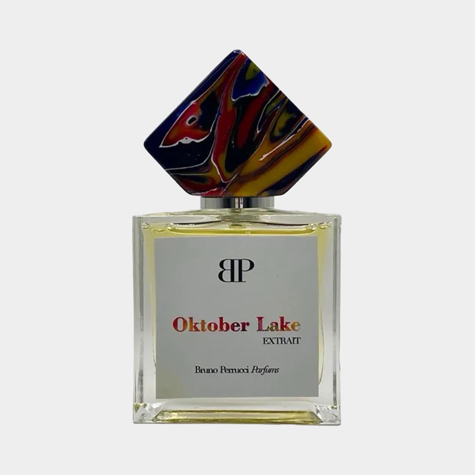 Bruno Perrucci Oktober Lake Sample - een elegant parfumflacon met een kunstzinnig, kleurrijk dopje en een eenvoudige maar verfijnde etiket.