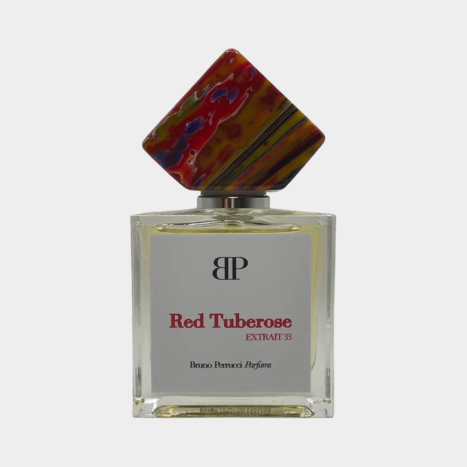 Bruno Perrucci Red Tuberose Sample is een elegant parfum met een opvallende fles, gekenmerkt door een unieke, kleurrijke dop en een etiket dat de geur benadrukt.