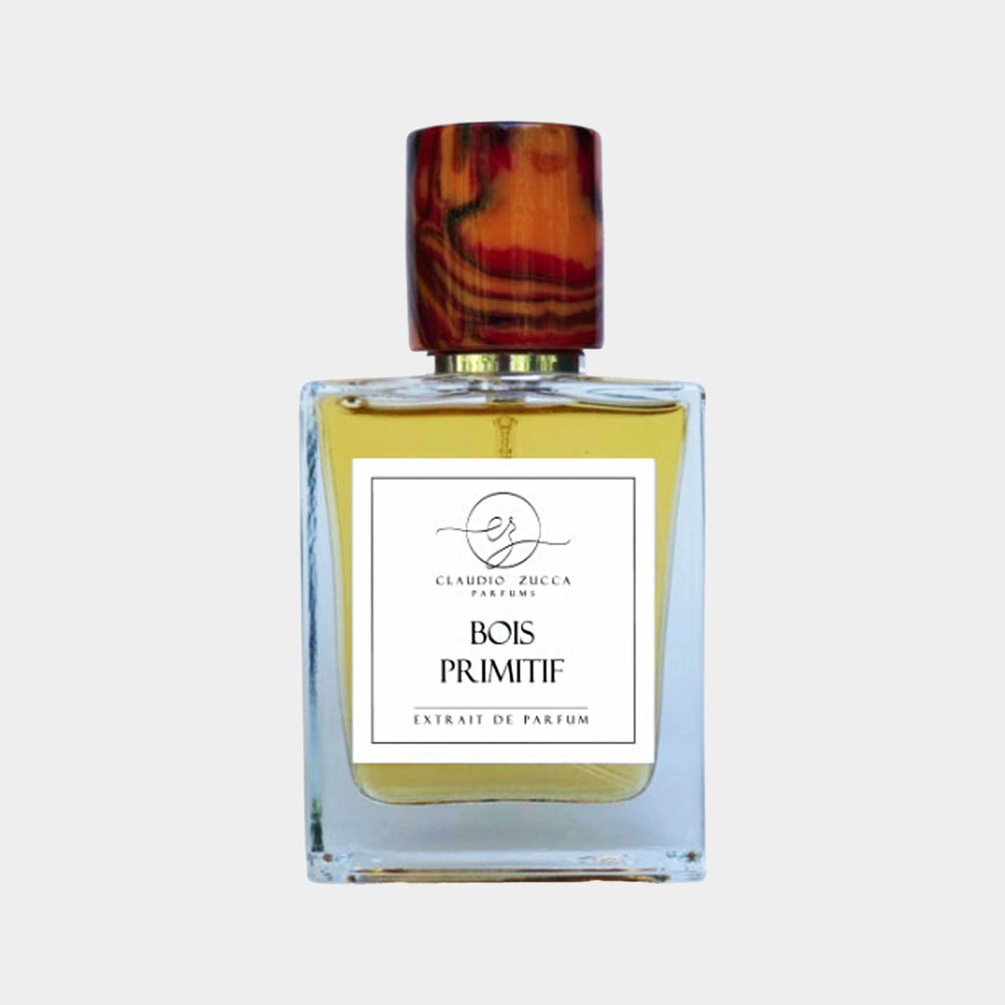 Flesje van Claudio Zucca Bois Primitif, een extrait de parfum met een elegante houten dop en een heldere, amberkleurige vloeistof.
