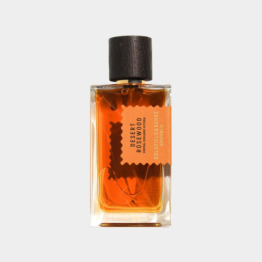 Goldfield & Banks Australia Desert Rosewood Sample in a glass bottle with an orange label and a wooden cap, showcasing a rich amber-colored fragrance.