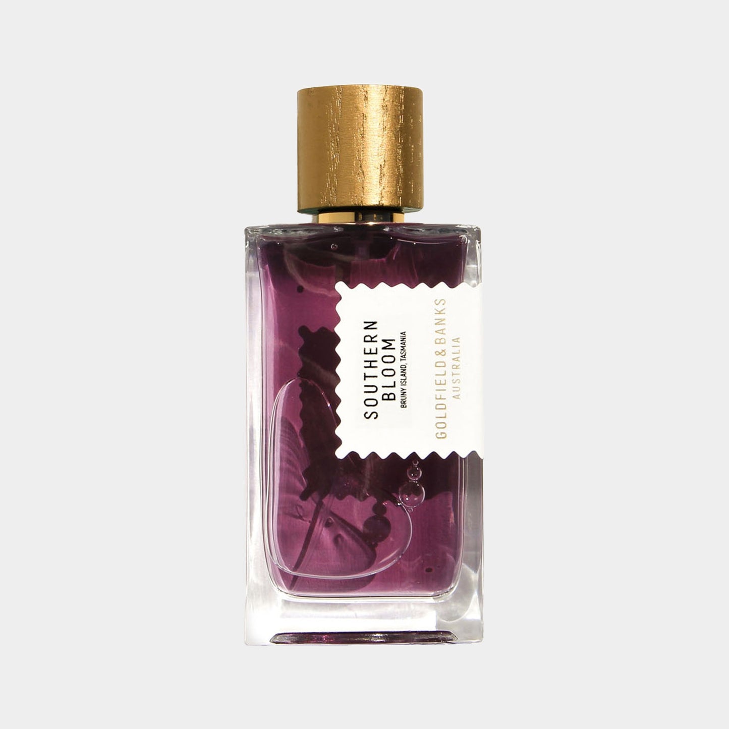 Goldfield & Banks Australia Southern Bloom sample, een elegant parfumflesje met een paarse vloeistof en een gouden dop, weerspiegelt de essentie van de Australische flora.