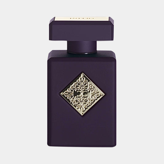 Initio Blessed Baraka Sample, een elegant zwart parfumflesje met een decoratieve gouden diamantvormige versiering op de voorkant.