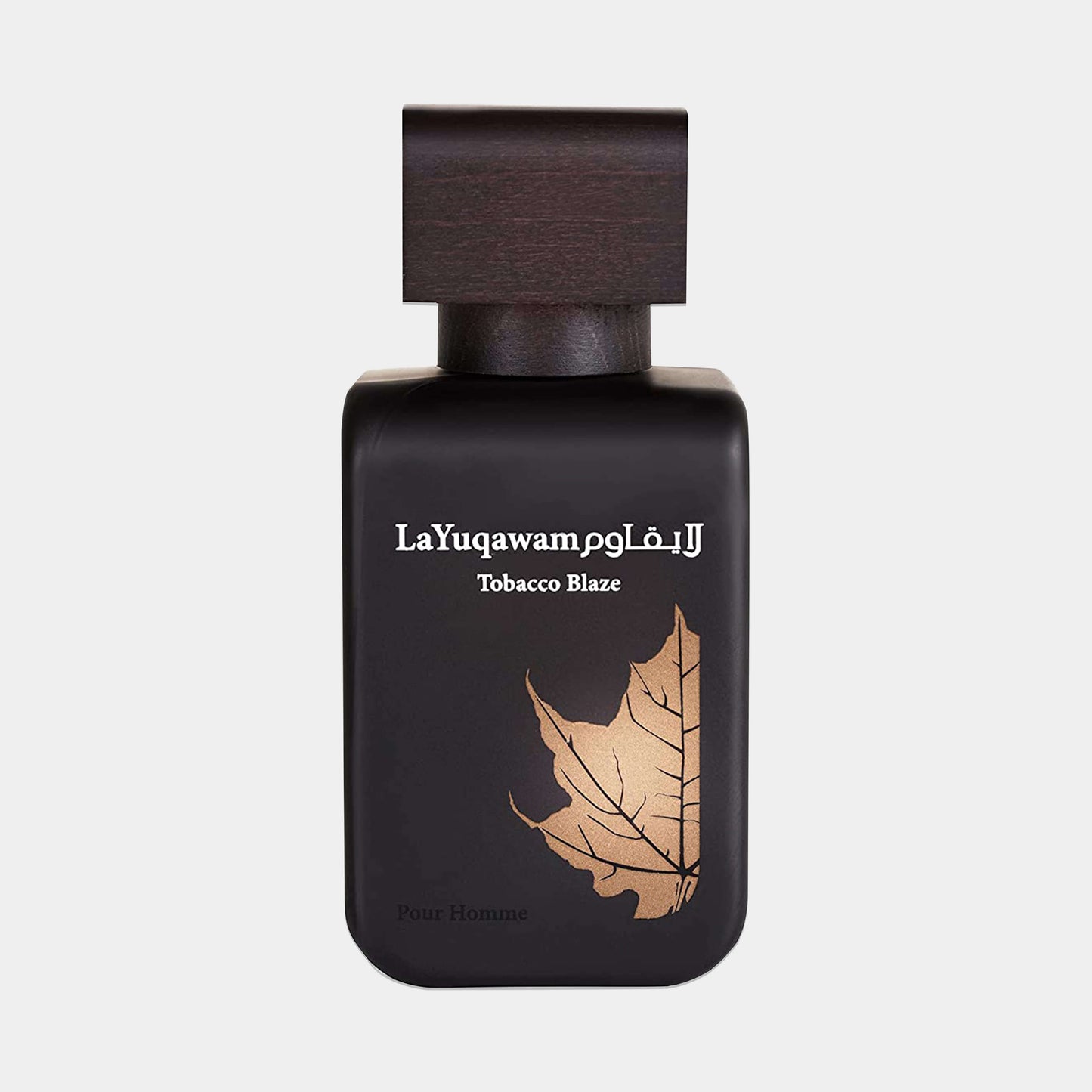 Rasasi La Yuqawam Tobacco Blaze Sample, een elegante parfumfles met een donkere afwerking en een gouden bladerenontwerp, ideaal voor mannen.