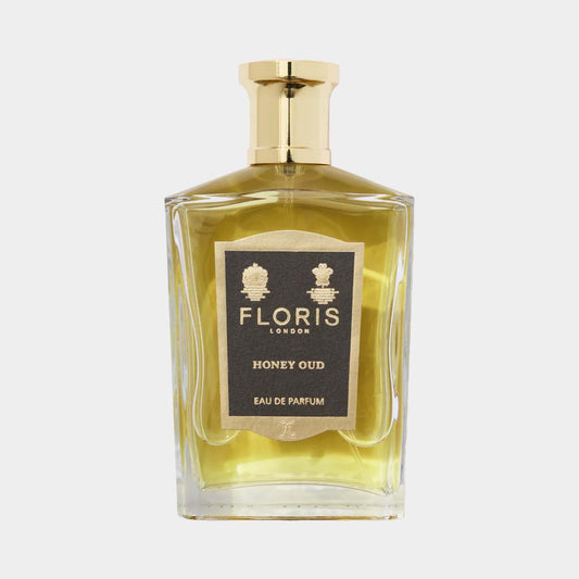 Floris London Honey Oud Eau de Parfum in een elegante, vierkante glazen fles met een gouden dop. De geur heeft een rijke mix van honing en houtachtige noten.