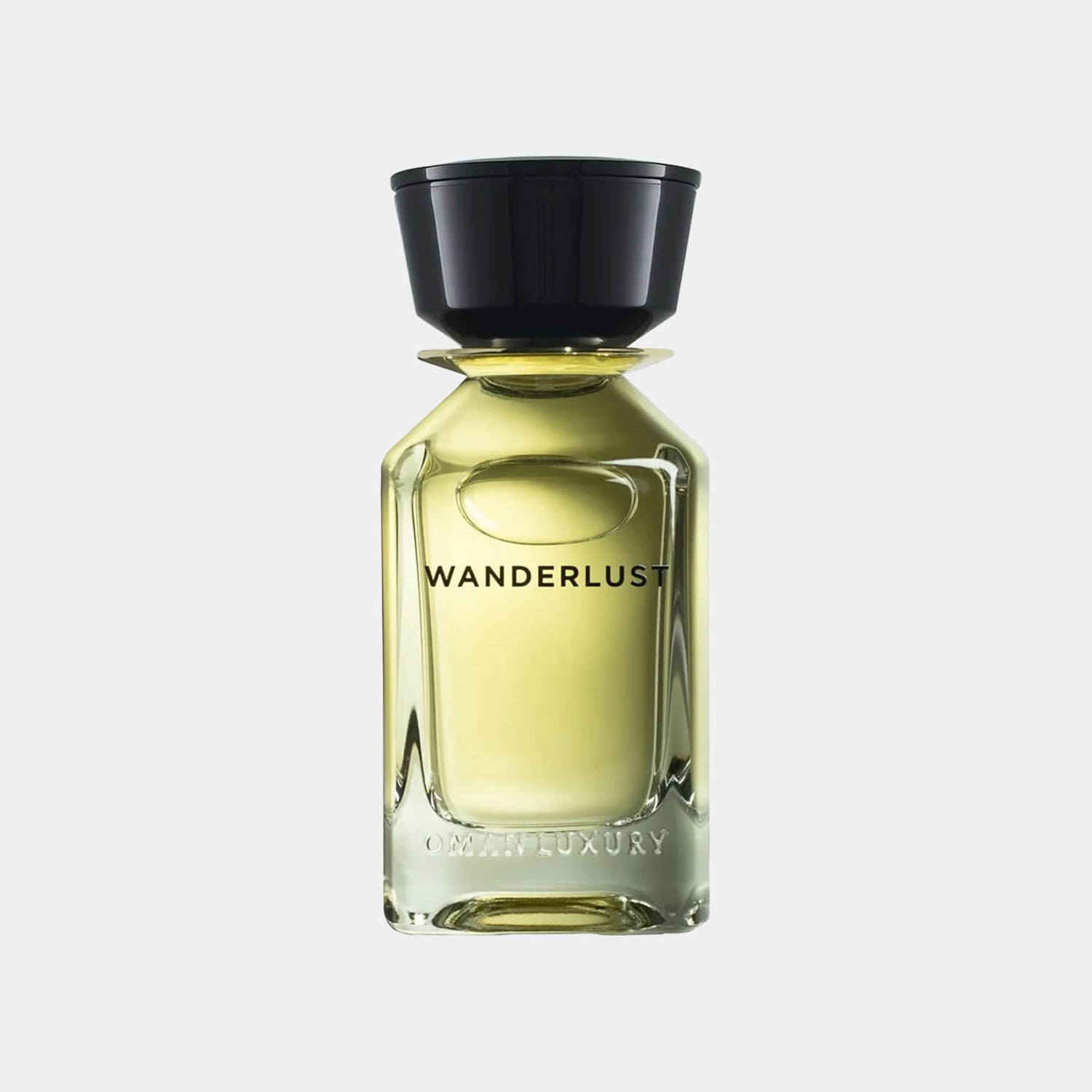 Flesje van Omanluxury Wanderlust Sample, een elegant parfum met een transparante glazen fles en een zwarte dop, perfect om de geur van avontuur vast te leggen.