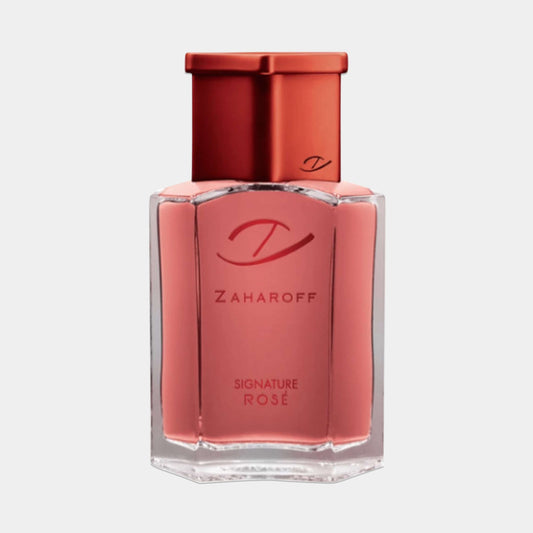 A small bottle of Zaharoff Signature Rose perfume, featuring a sleek design with a pink liquid and a stylish copper cap, showcasing the brand's elegant logo.